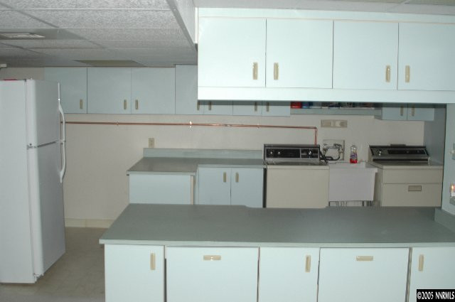 1281 University Terrace Reno, NV 89503 - Photo 3 of 5 a kitchen with white cabinets and a refrigerator