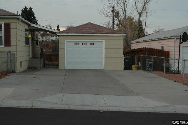 1281 University Terrace Reno, NV 89503 - Photo 4 of 5 a front view of a house with a yard and garage