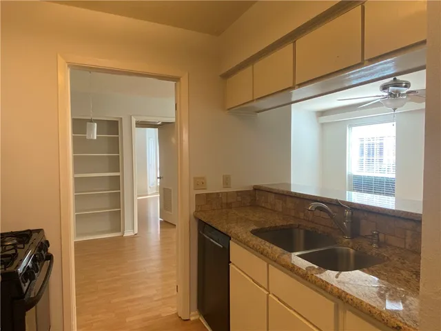a kitchen that has a sink and a stove