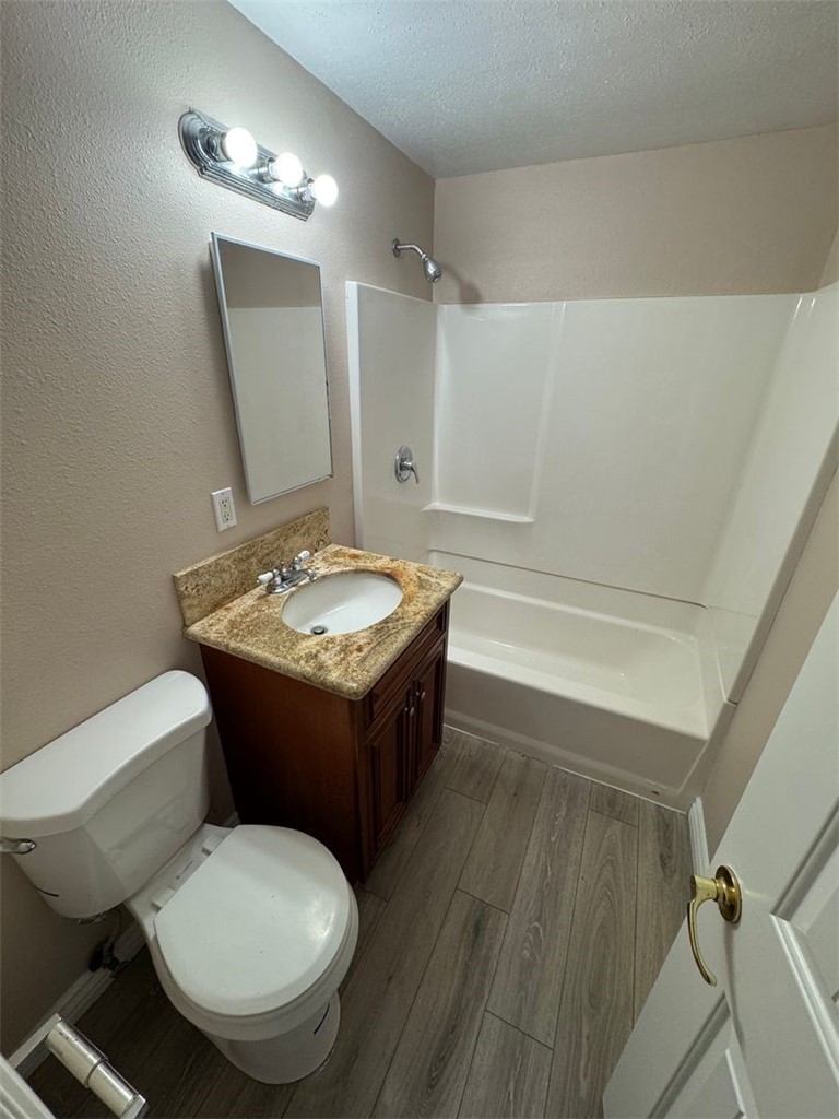 3338 Vance Street Riverside, CA 92504 - Photo 6 of 11 a bathroom with a toilet a sink and mirror