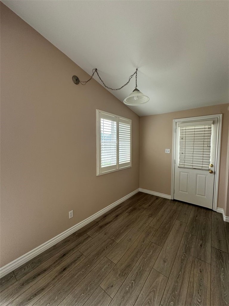 3338 Vance Street Riverside, CA 92504 - Photo 9 of 11 a view of an empty room with wooden floor and a window