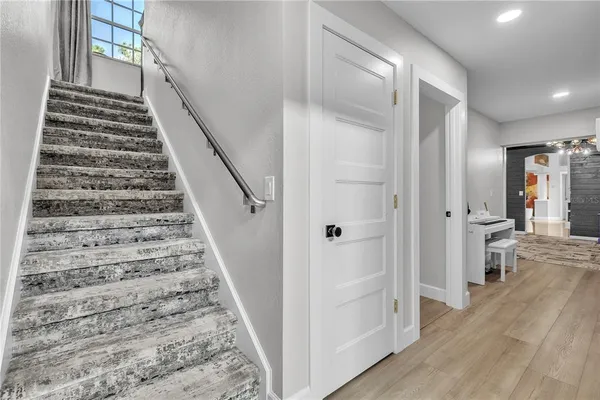 a bathroom with a granite countertop bathtub sink vanity mirror and toilet