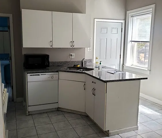 a kitchen with stainless steel appliances granite countertop a sink stove and microwave