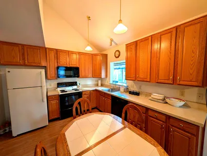 a kitchen with stainless steel appliances a refrigerator sink and cabinets