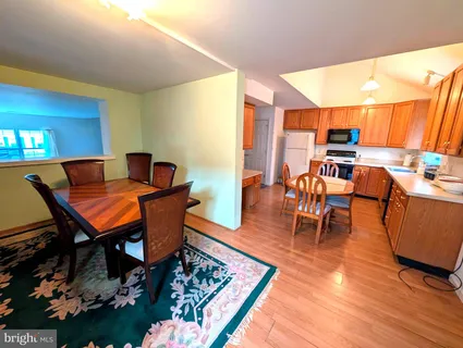 a living room with furniture a rug and a table