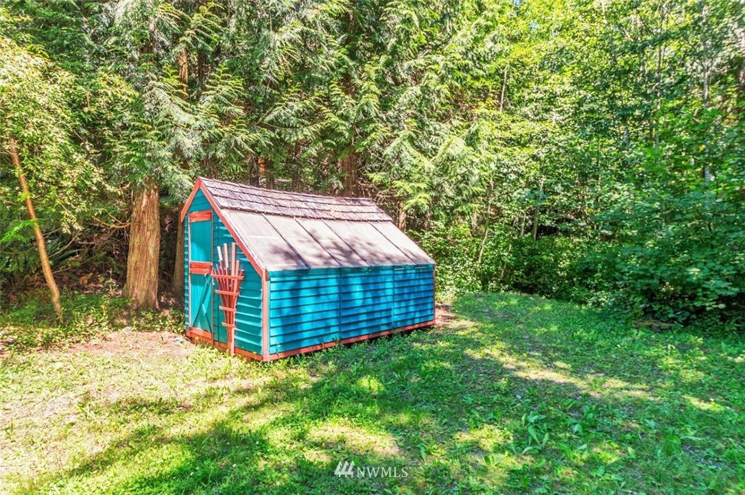 105 Naylor Creek Road Chimacum, WA 98325 - Photo 23 of 24 a view of a backyard with a small cabin