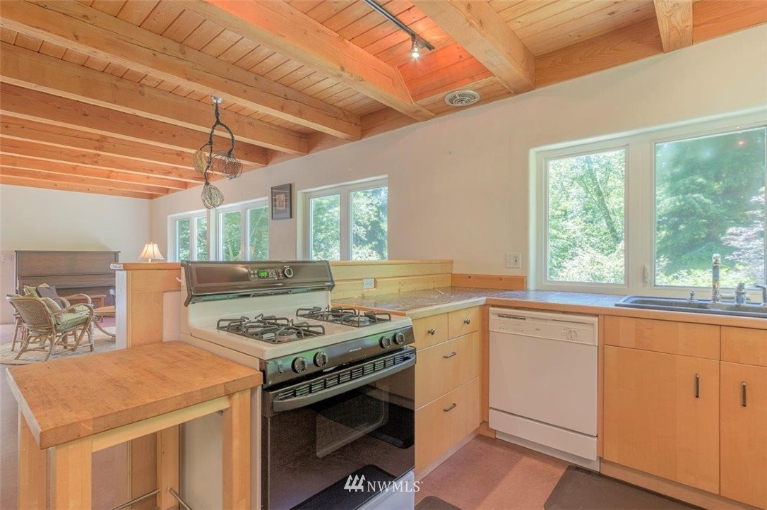105 Naylor Creek Road Chimacum, WA 98325 - Photo 10 of 24 a kitchen that has a stove and a sink