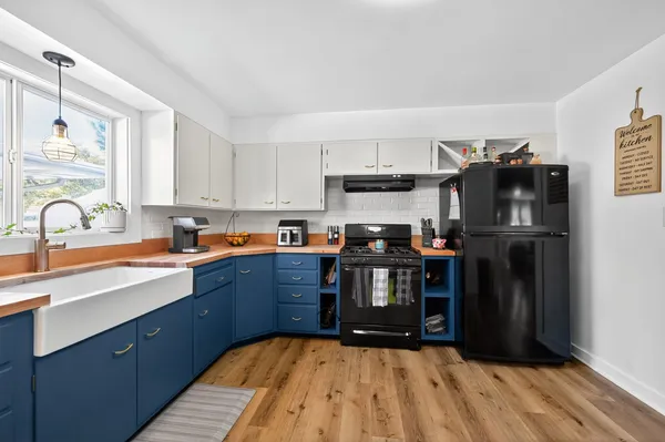 a kitchen with stainless steel appliances granite countertop a refrigerator and a sink