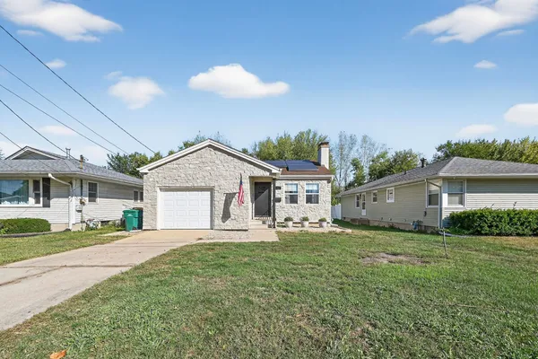 a house view with a sitting space and garden