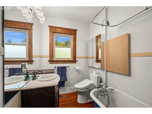 a bathroom with a sink toilet a mirror and shower