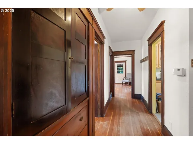 a view of hallway with wooden floor