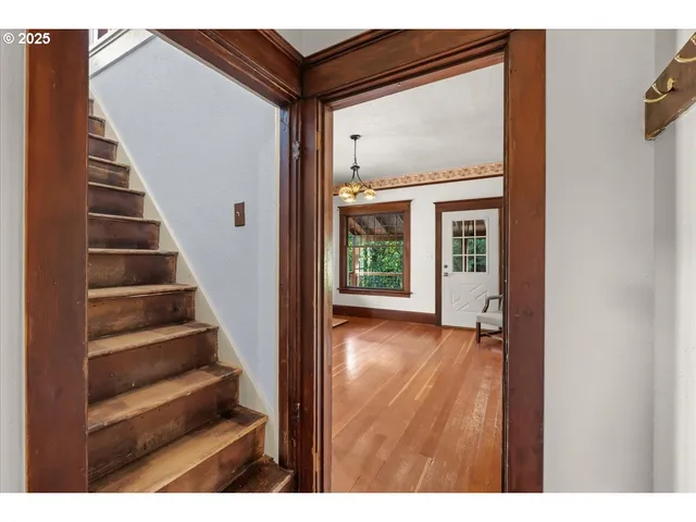a view of entryway and hall with wooden floor