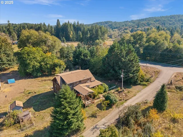 an aerial view of a house with a yard