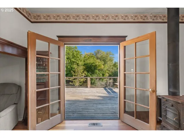 a view of a balcony with wooden floor and fence