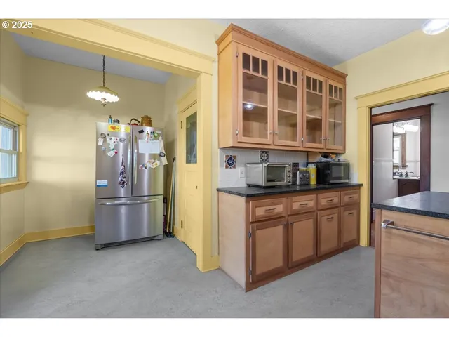 a kitchen with refrigerator and window