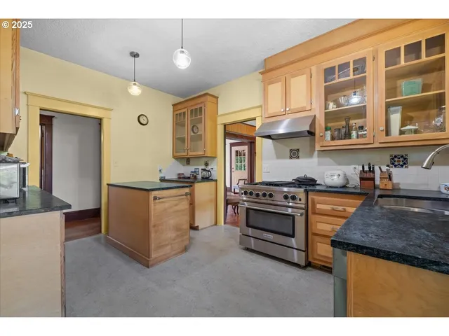 a kitchen with stainless steel appliances granite countertop a stove and a sink