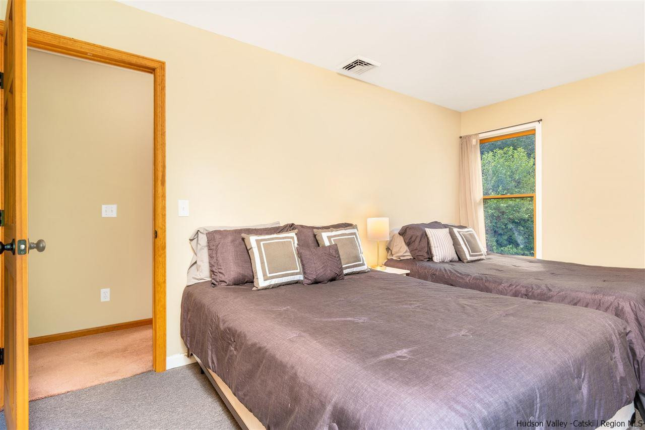58 Old Powdermill Road Saugerties, NY 12477 - Photo 13 of 35 a bedroom with a large bed and a large window