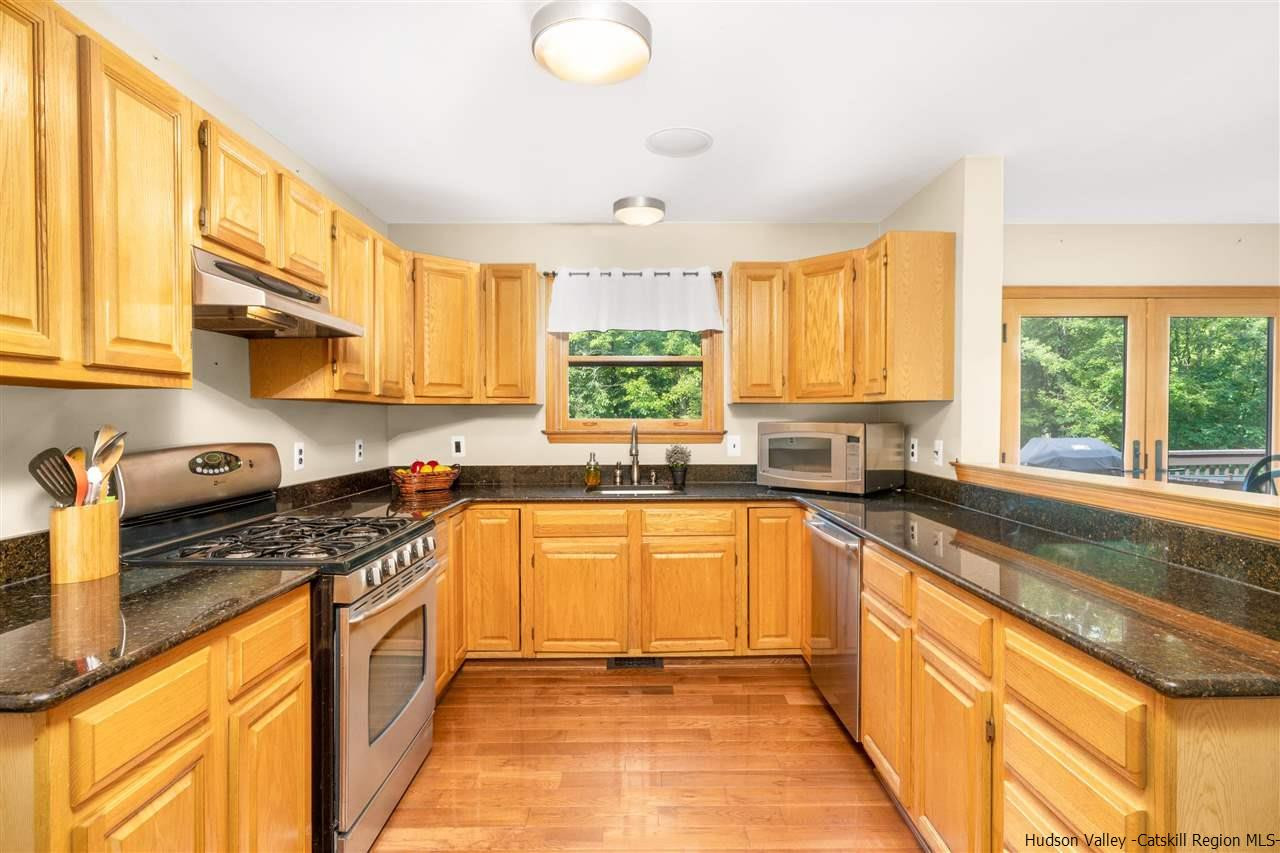 58 Old Powdermill Road Saugerties, NY 12477 - Photo 7 of 35 a kitchen with stainless steel appliances granite countertop sink stove refrigerator and cabinets