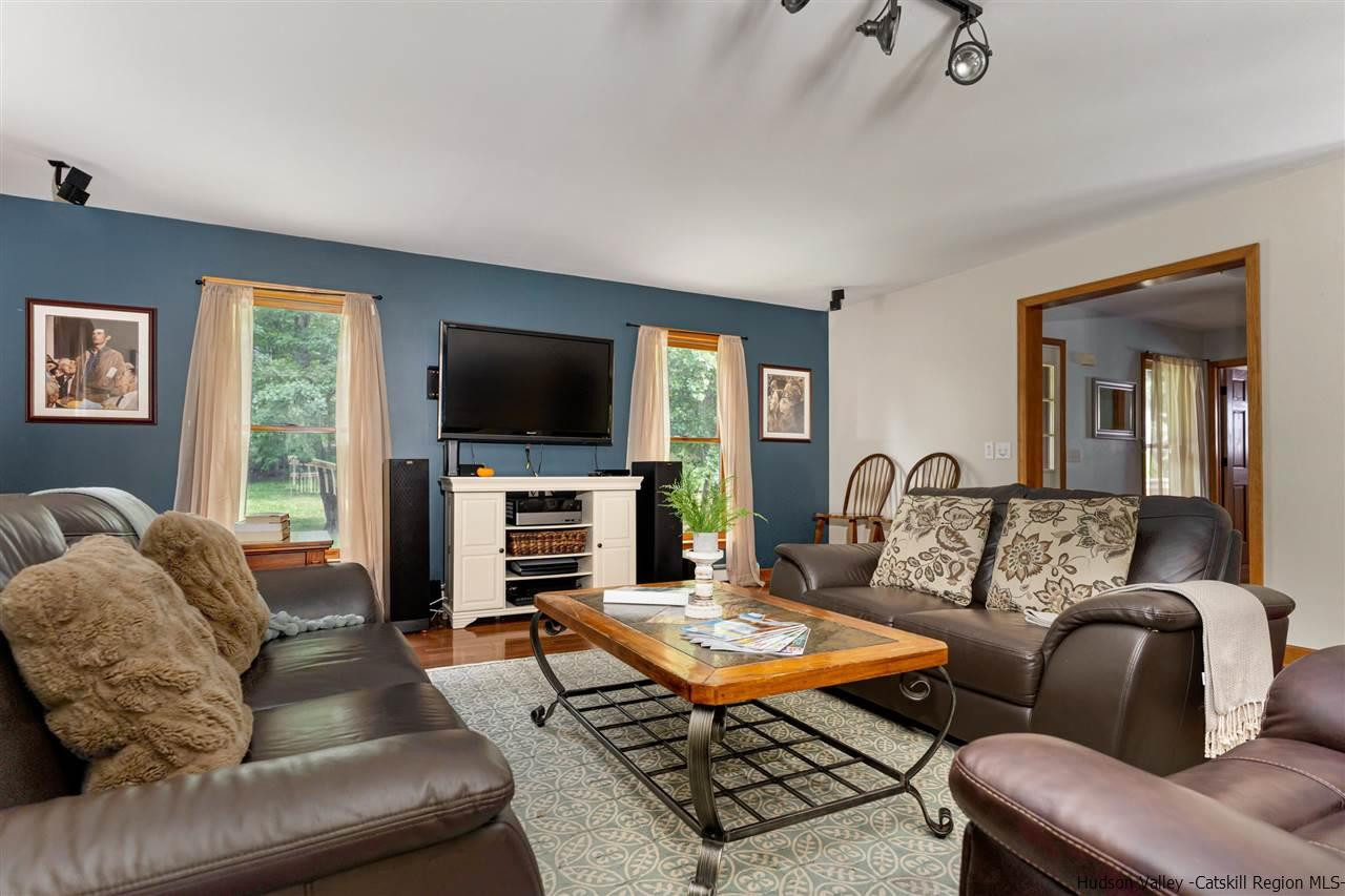58 Old Powdermill Road Saugerties, NY 12477 - Photo 9 of 35 a living room with fireplace furniture and a flat screen tv