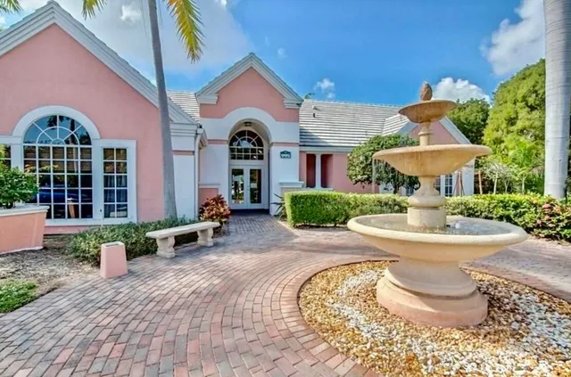 a front view of a house with yard and outdoor seating
