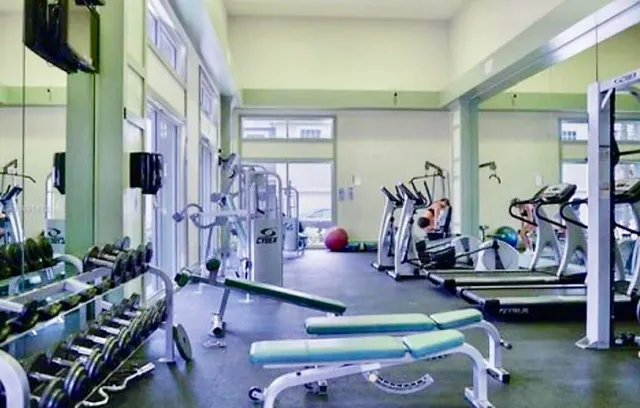 a room with lots of gym equipment