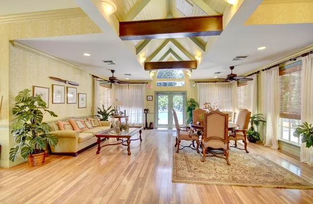 a living room with furniture a wooden floor and a chandelier