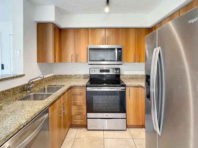 a kitchen with a refrigerator sink and microwave