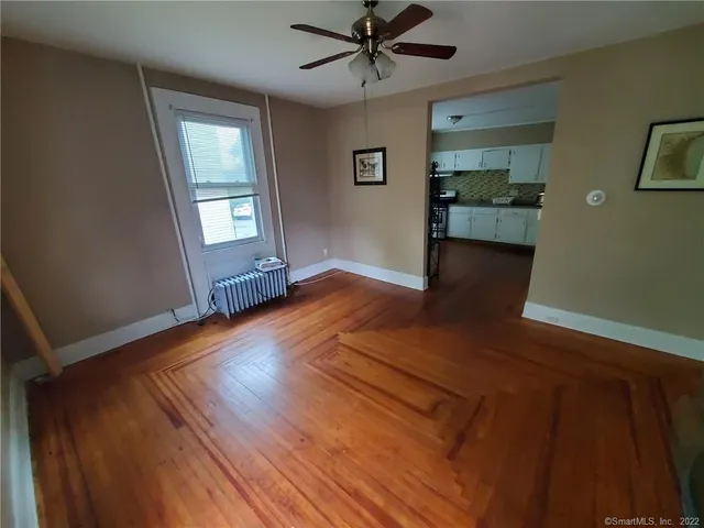 wooden floor in an empty room with a window