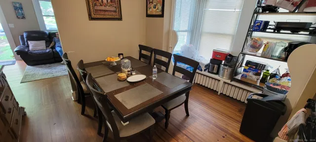 a view of a workspace with furniture and wooden floor