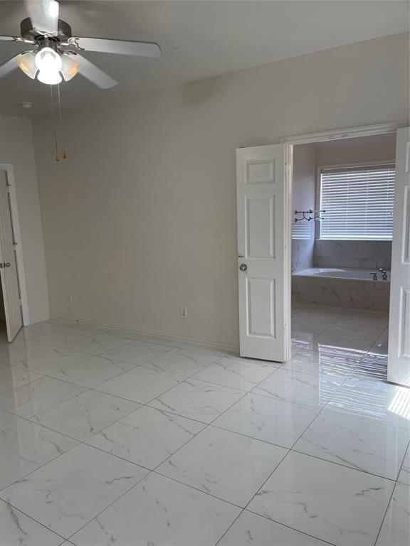 1004 Concan Drive Forney, TX 75126 - Photo 16 of 24 an empty room with closet and a chandelier fan