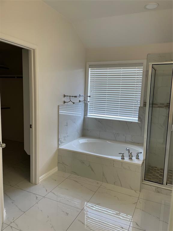 1004 Concan Drive Forney, TX 75126 - Photo 20 of 24 a bathroom with a bathtub and a sink
