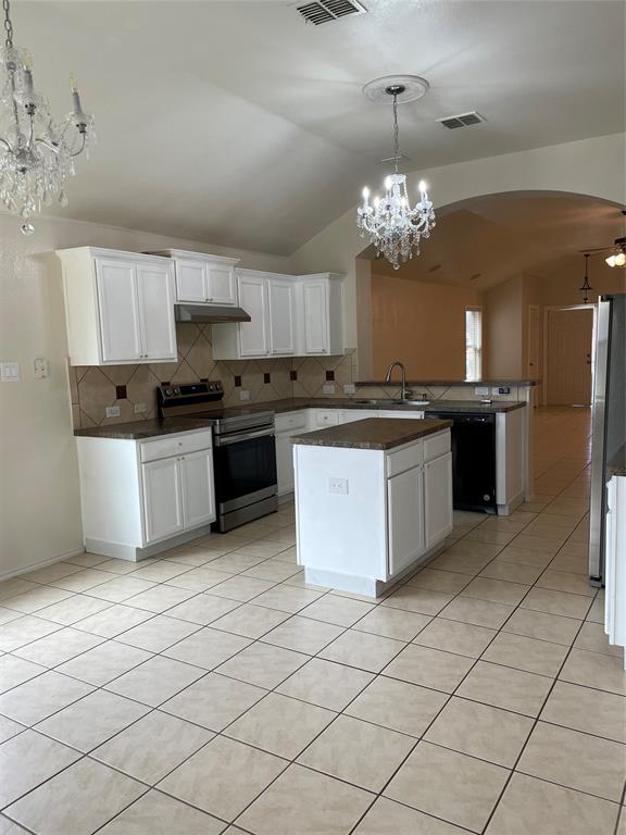 1004 Concan Drive Forney, TX 75126 - Photo 7 of 24 a kitchen with stainless steel appliances granite countertop a stove top oven a sink dishwasher and a refrigerator
