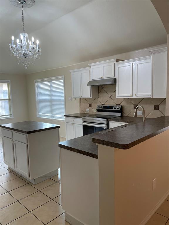 1004 Concan Drive Forney, TX 75126 - Photo 8 of 24 a kitchen with stainless steel appliances granite countertop a sink a stove a refrigerator a washer dryer and a cabinets