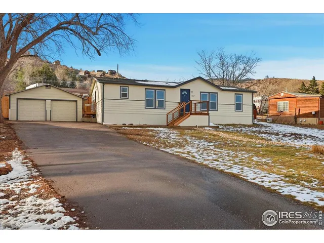 a view of a house with a snow in the background