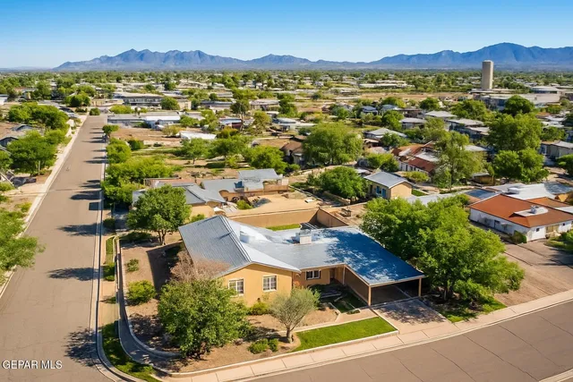 an aerial view of residential houses with outdoor space and street view