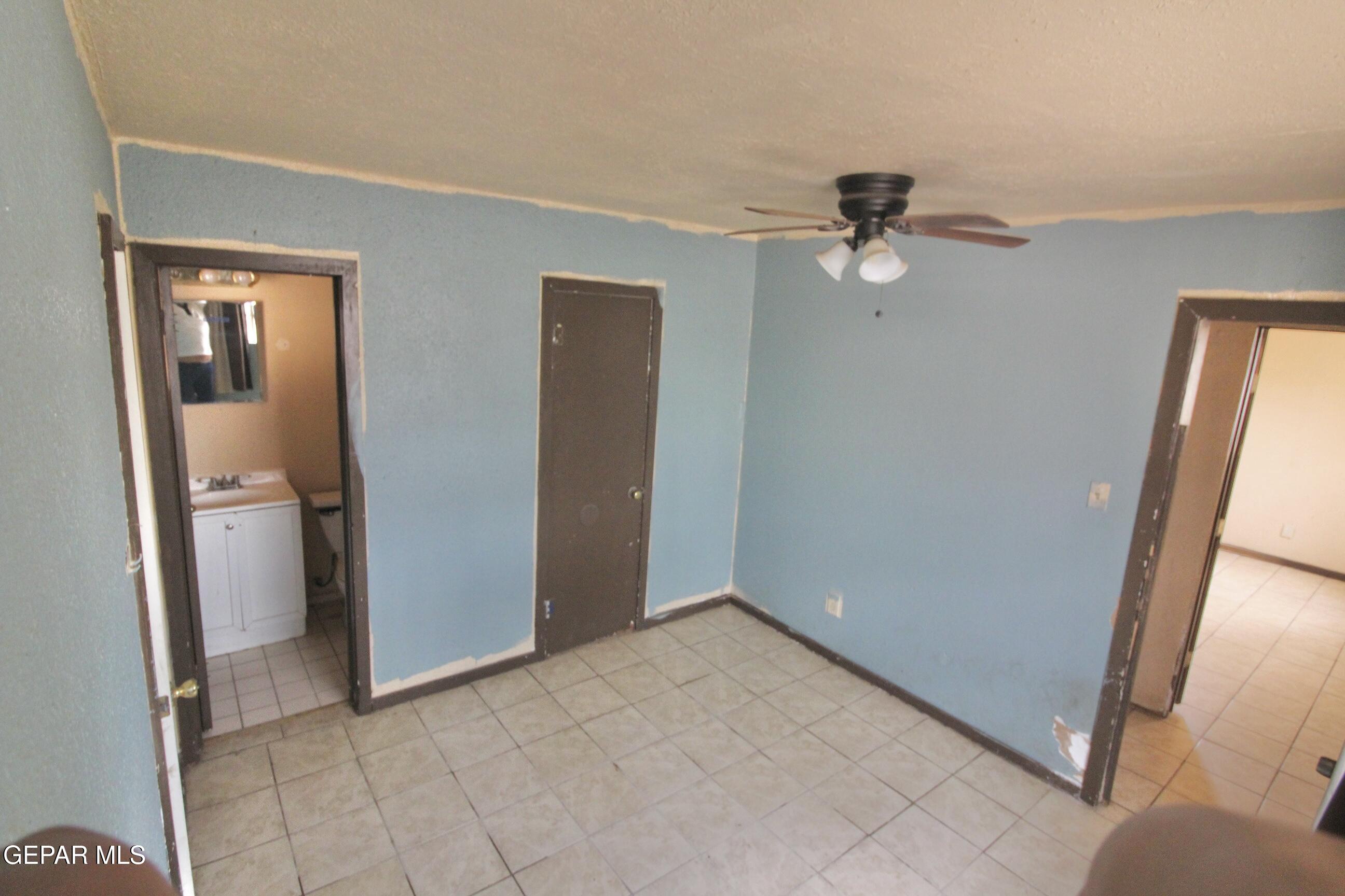 525 Margarita Street Anthony, TX 79821 - Photo 17 of 20 an empty room with closet and a chandelier fan
