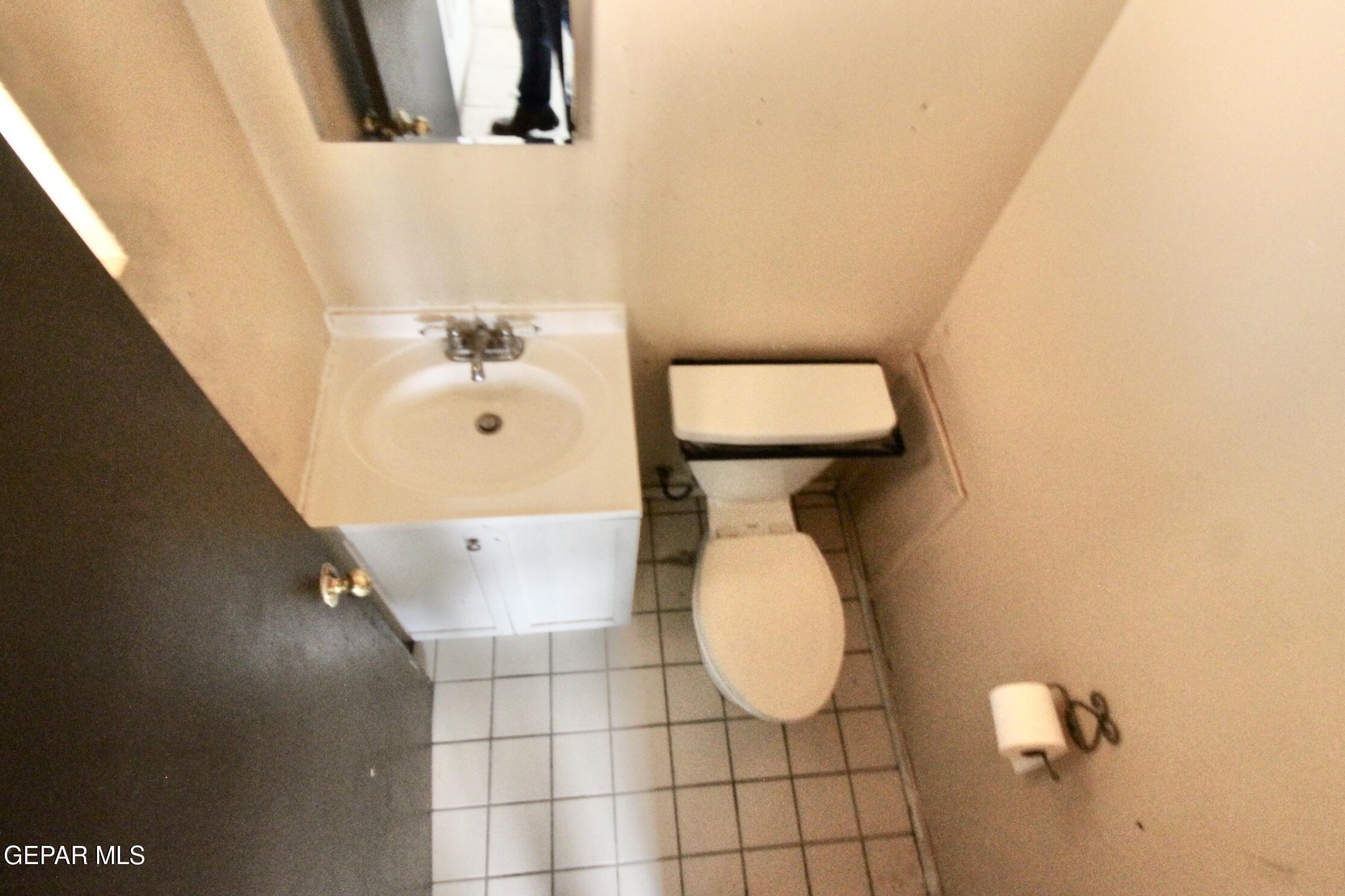 525 Margarita Street Anthony, TX 79821 - Photo 10 of 20 a bathroom with a toilet and a mirror