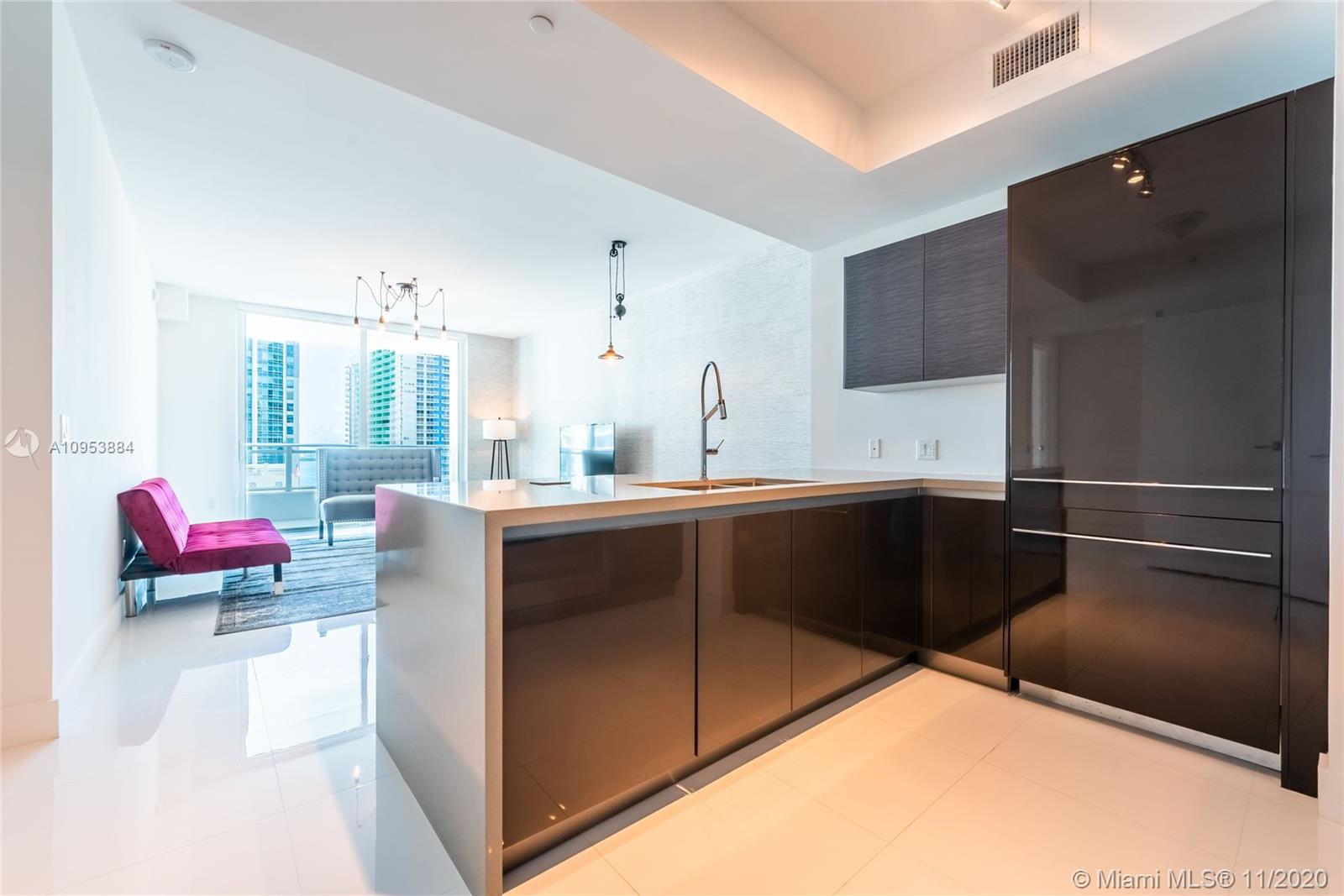 The Bond Miami, FL 33131 - Photo 5 of 19 a kitchen with stainless steel appliances kitchen island granite countertop a refrigerator and a sink
