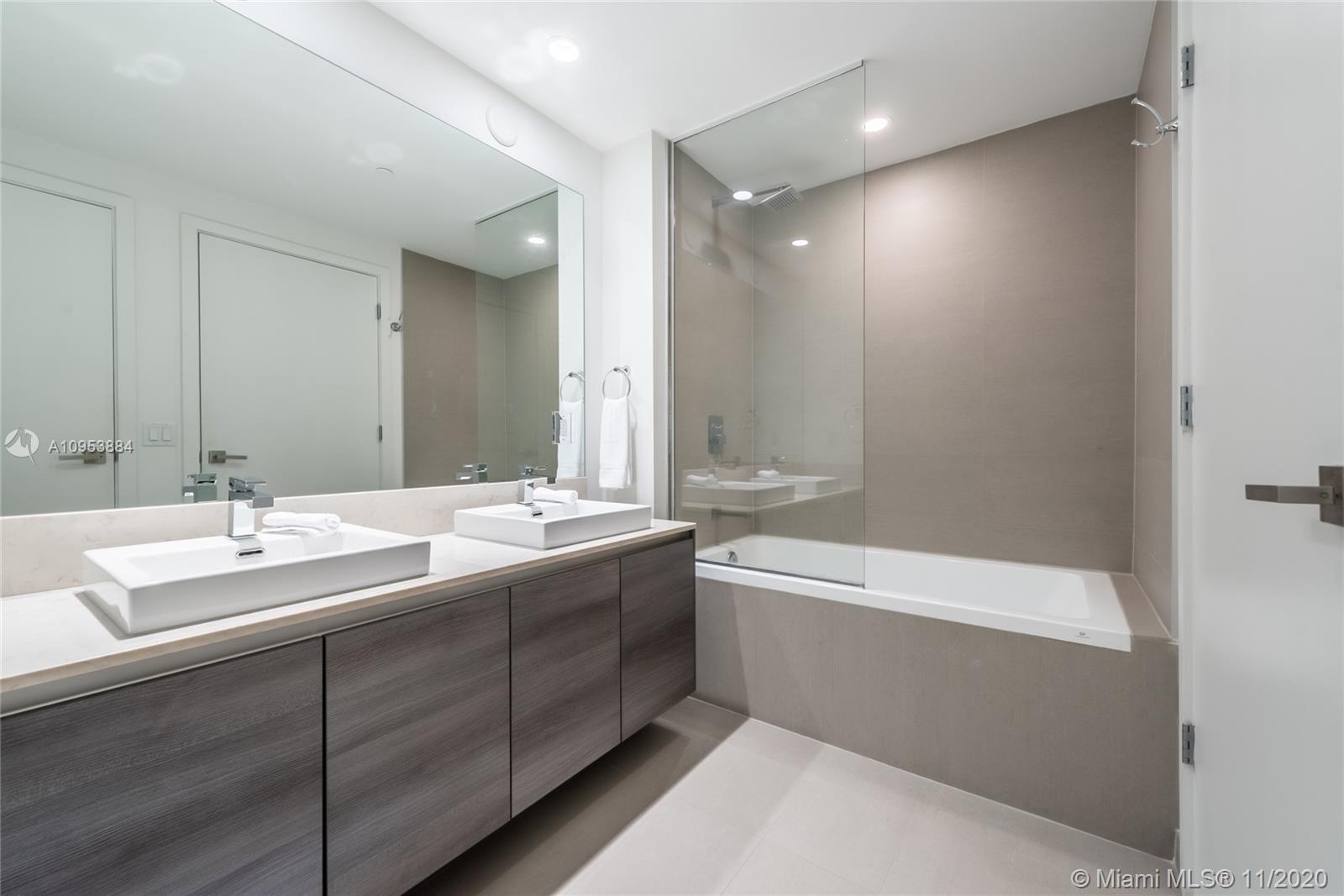 The Bond Miami, FL 33131 - Photo 7 of 19 a bathroom with a double vanity sink mirror double and bathtub