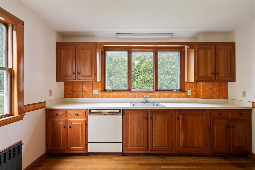 38 Bailey Road Arlington, MA 02476 - Photo 11 of 30 a kitchen with wooden cabinets and a sink