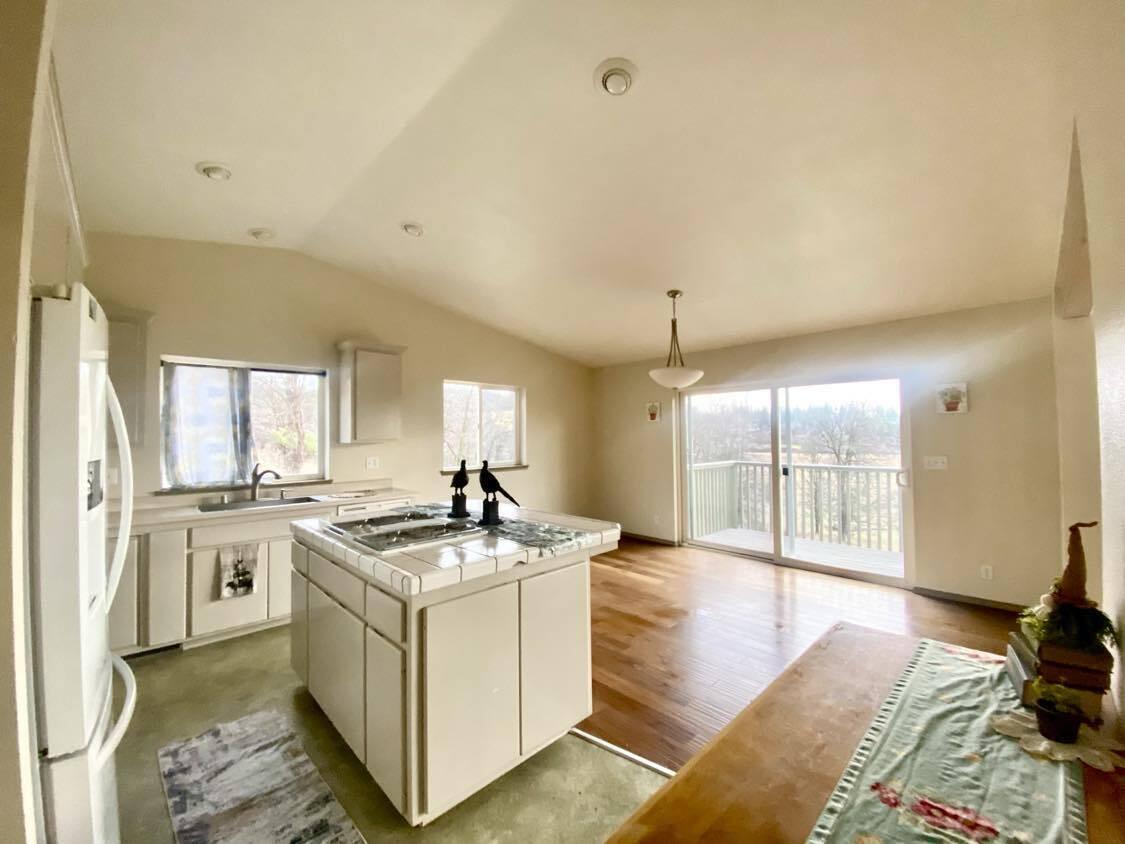 13080 Fern Road Whitmore, CA 96096 - Photo 17 of 49 a kitchen that has a lot of white cabinets and stainless steel appliances