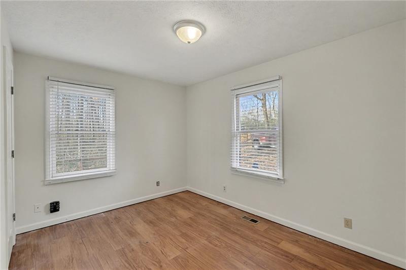 3800 Tyus Carrollton Road Carrollton, GA 30117 - Photo 20 of 36 a view of an empty room with a window and wooden floor