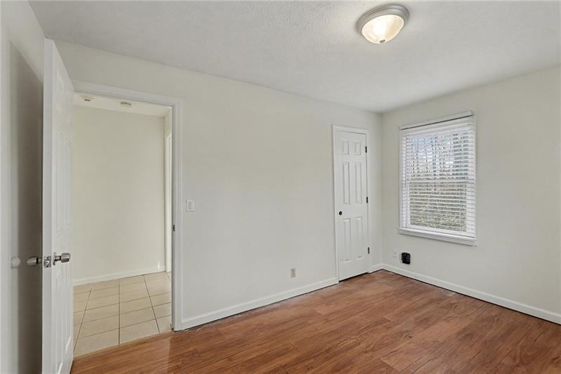 3800 Tyus Carrollton Road Carrollton, GA 30117 - Photo 21 of 36 an empty room with wooden floor and windows