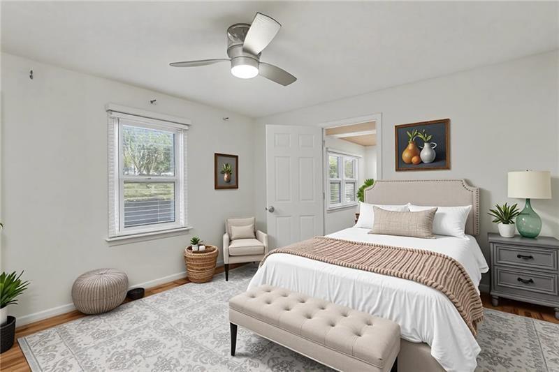 3800 Tyus Carrollton Road Carrollton, GA 30117 - Photo 22 of 36 a bedroom with a bed and a chandelier