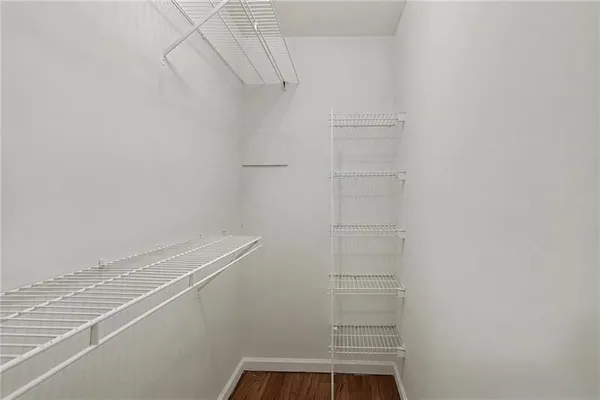 a view of walk in closet with empty racks