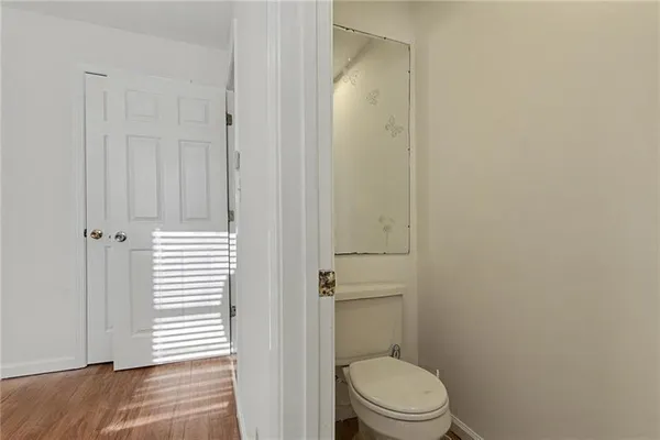 a white toilet sitting next to a shower