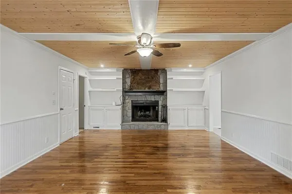 a view of a livingroom with a fireplace a chandelier and stairs