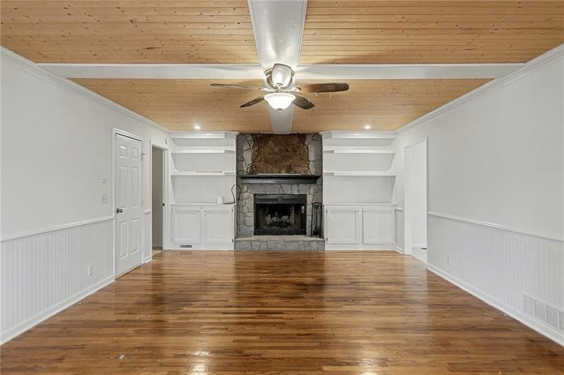 3800 Tyus Carrollton Road Carrollton, GA 30117 - Photo 7 of 36 a view of a livingroom with a fireplace a chandelier and stairs