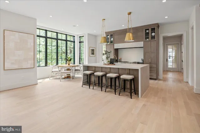 a large kitchen with kitchen island granite countertop a sink and a large window