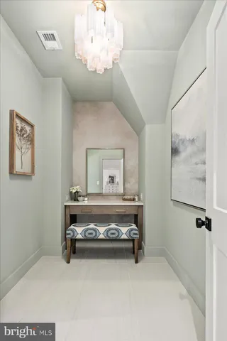 a kitchen with stainless steel appliances kitchen island granite countertop a table chairs and a refrigerator